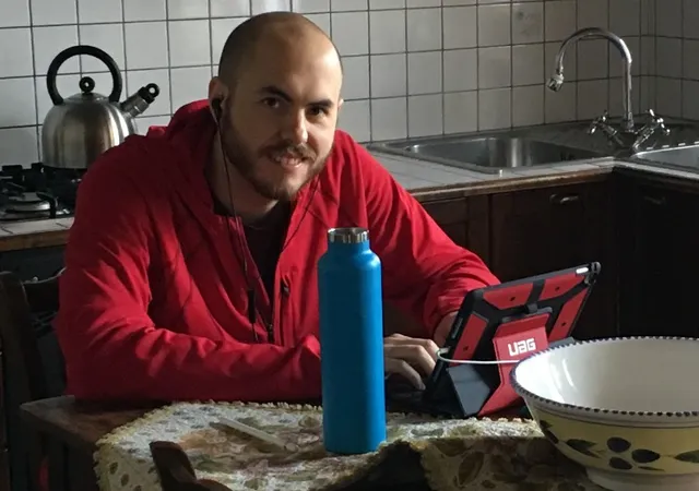 Nicholas Licalsi working at a kitchen table